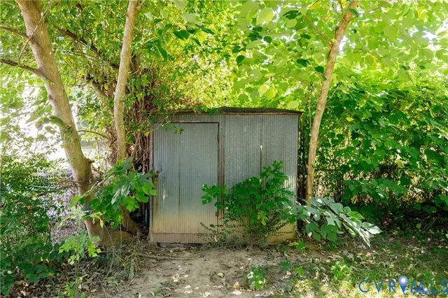 a backyard of a house with plants and tree
