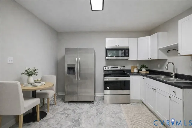 a kitchen with a sink cabinets and stainless steel appliances