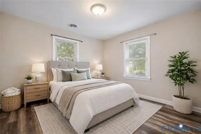 a bedroom with a bed and a potted plant