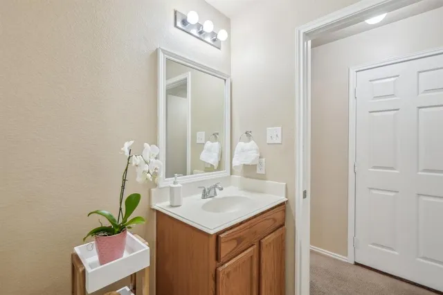 a bathroom with a sink a mirror and a shower