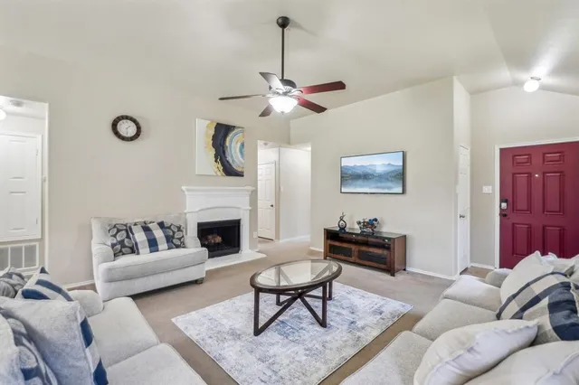 a living room with furniture a rug and a fireplace