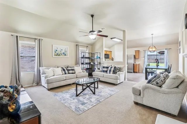 a living room with furniture or couch and a chandelier