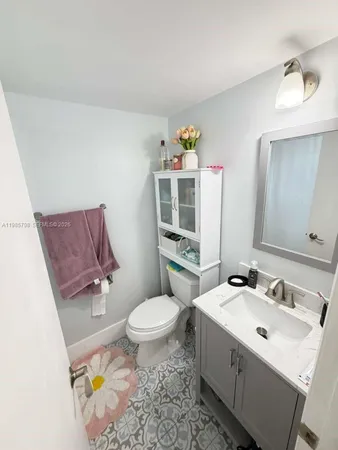a bathroom with a sink mirror vanity and toilet