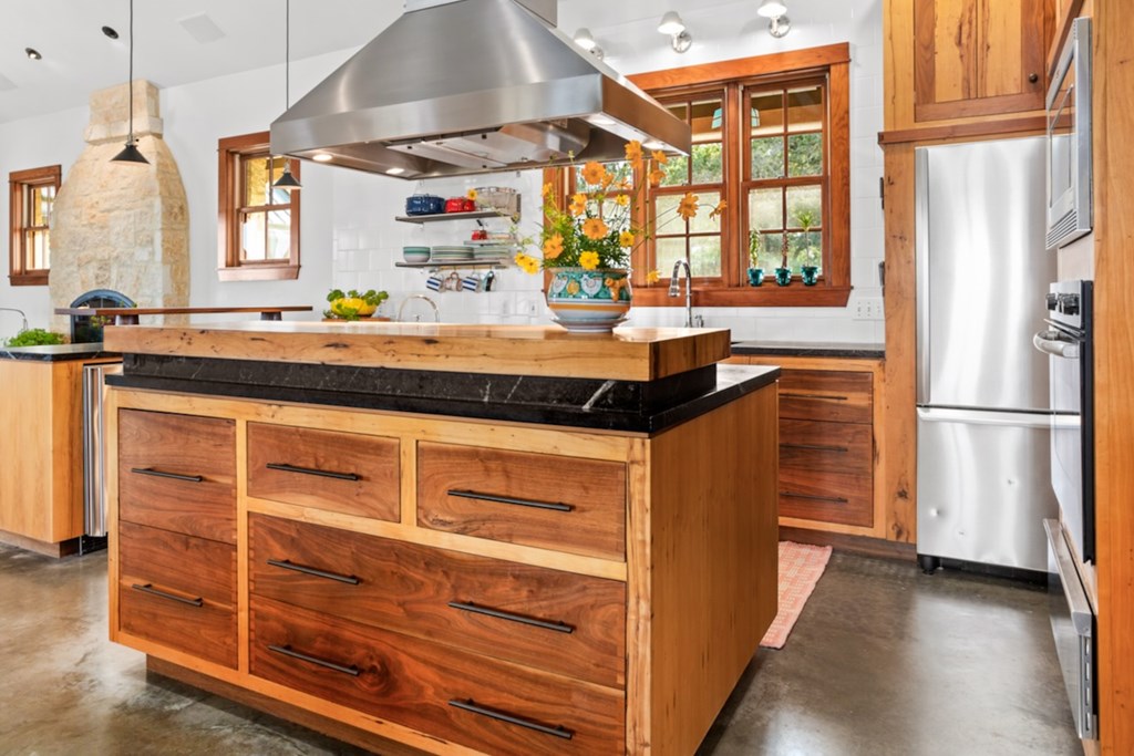 309 Ridgeview Drive Fredericksburg, TX 78624 - Photo 14 of 32 a kitchen with stainless steel appliances granite countertop a stove and a refrigerator