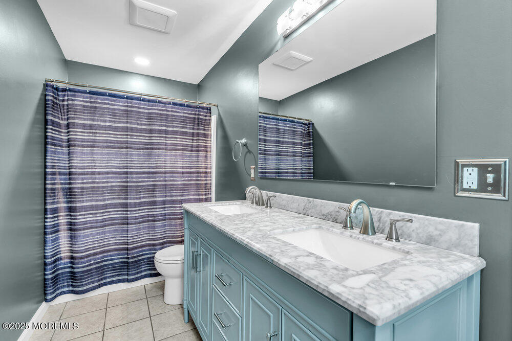 225 East Bird Village Road Jackson, NJ 08527 - Photo 43 of 69 a bathroom with a granite countertop sink a toilet and mirror