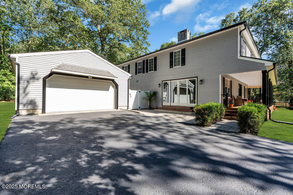 225 East Bird Village Road Jackson, NJ 08527 - Photo 6 of 69 a front view of a house with a yard and garage