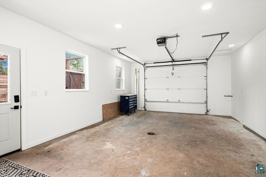 1825 East Shilhon Road Duluth, MN 55804 - Photo 34 of 37 Spacious garage heated & finished w/ separate access to 4th bath- a sauna/shower & also to a private, enclosed pergola & hot tub area.