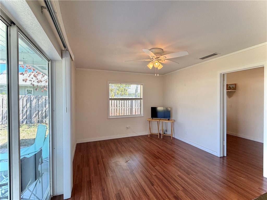 715 Holly Road Vero Beach, FL 32963 - Photo 11 of 25 a view of an empty room with a window and wooden floor