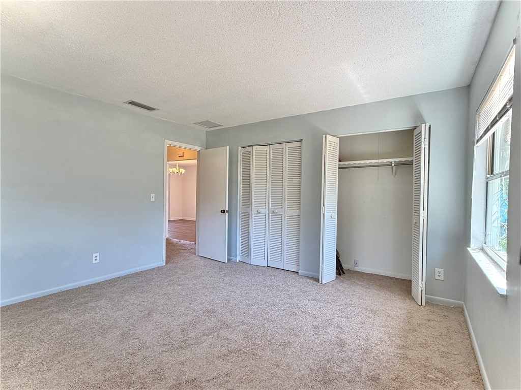 715 Holly Road Vero Beach, FL 32963 - Photo 13 of 25 an empty room with windows and closet