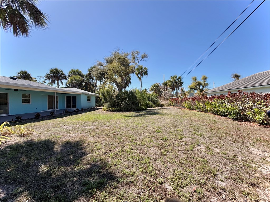 715 Holly Road Vero Beach, FL 32963 - Photo 20 of 25 a front view of a house with a yard and garage