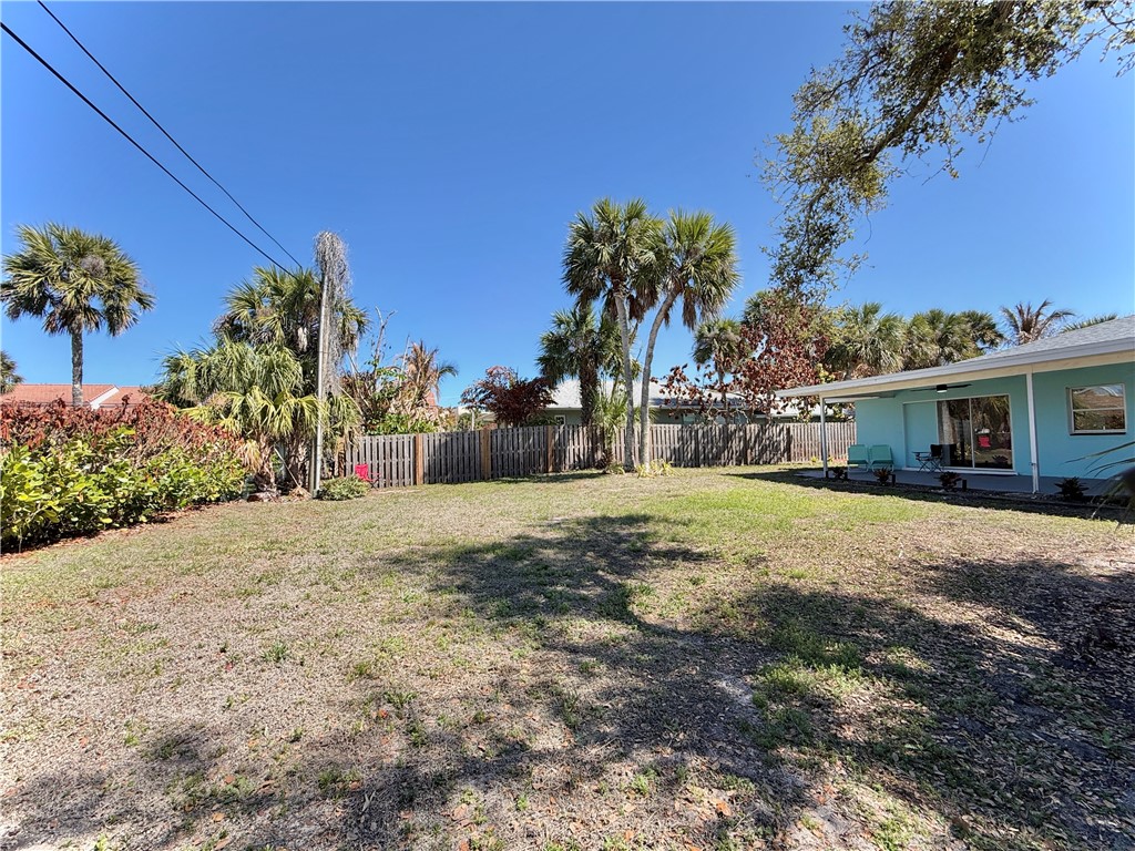 715 Holly Road Vero Beach, FL 32963 - Photo 21 of 25 a front view of a house with a yard and potted plants