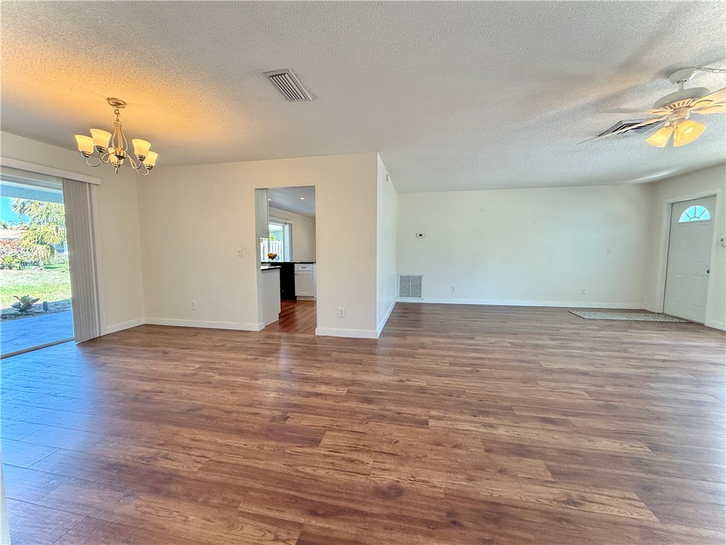 715 Holly Road Vero Beach, FL 32963 - Photo 5 of 25 a view of empty room with wooden floor and fan