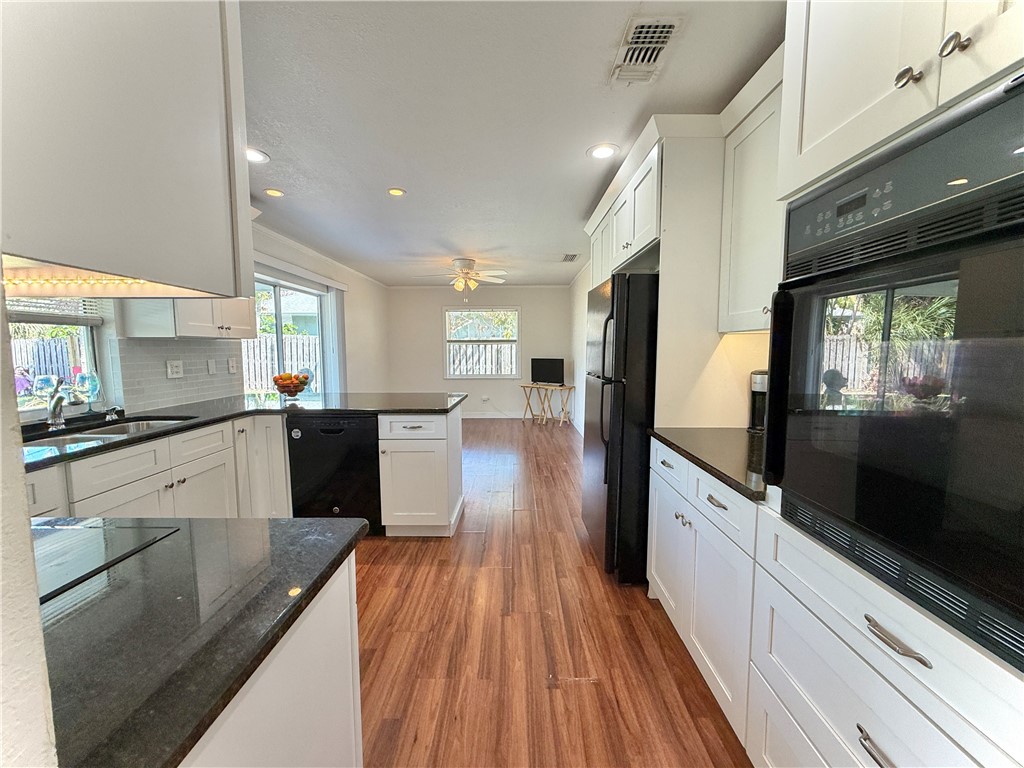 715 Holly Road Vero Beach, FL 32963 - Photo 7 of 25 a large kitchen with stainless steel appliances kitchen island a large counter top and a stove