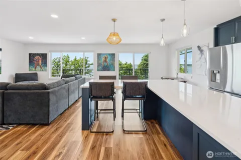 a kitchen with stainless steel appliances granite countertop a sink a stove and a refrigerator