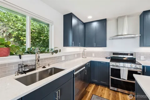 a kitchen with a sink stove top oven and cabinets