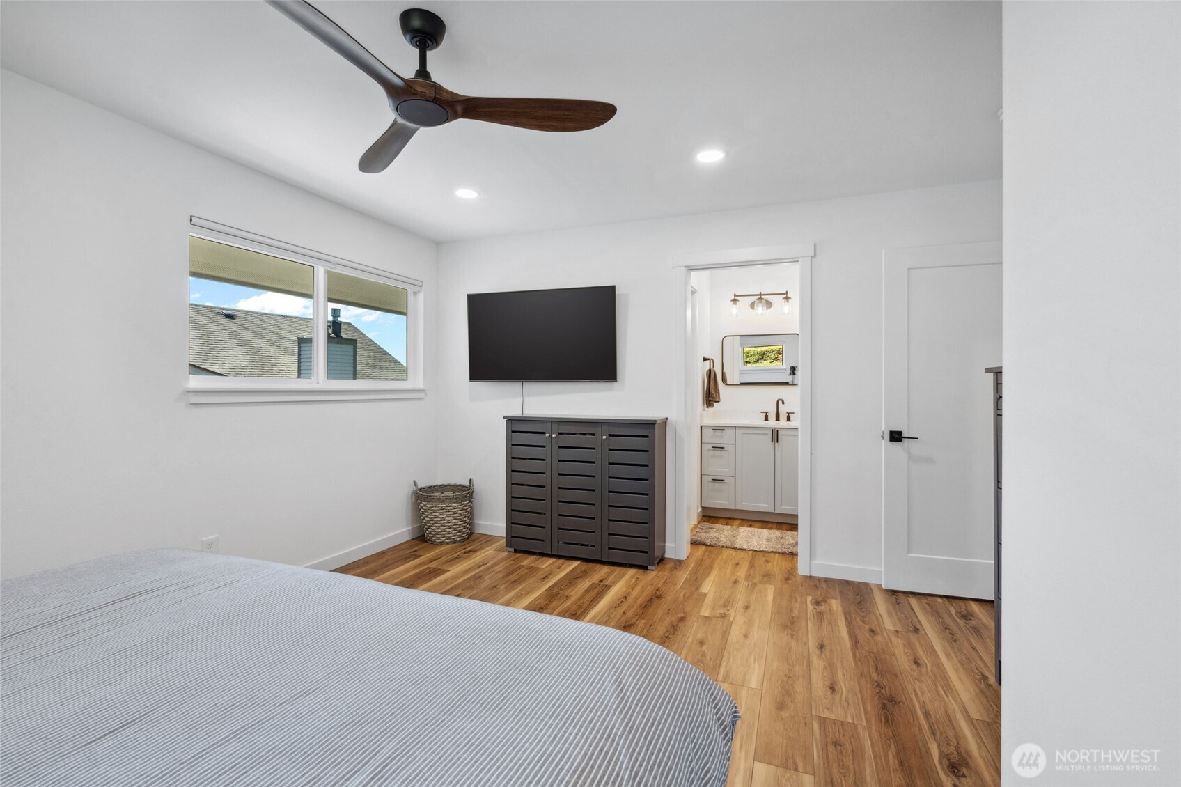 201 South State Street, Unit B Bellingham, WA 98225 - Photo 19 of 40 a bedroom with a bed and a flat screen tv