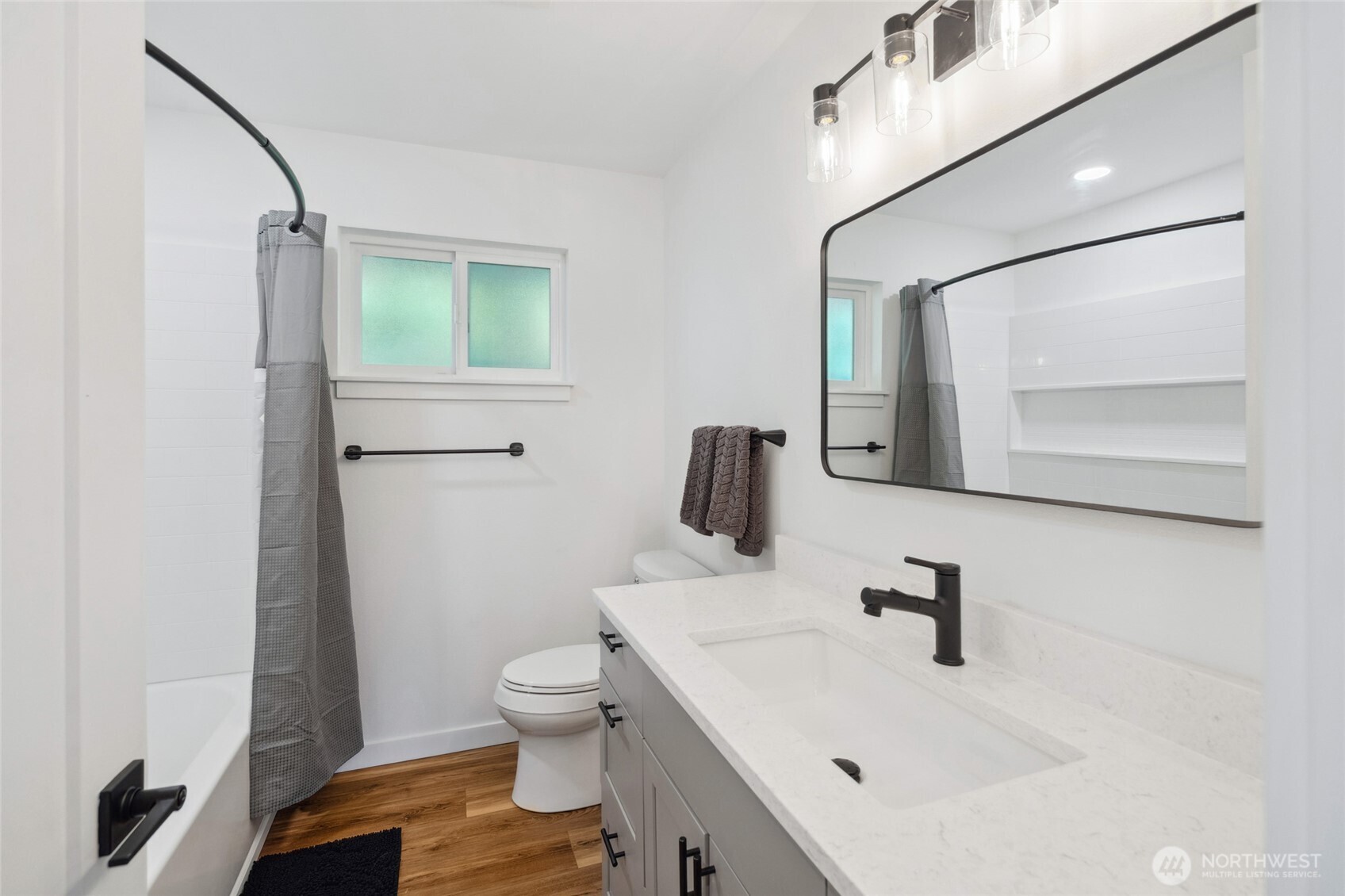 201 South State Street, Unit B Bellingham, WA 98225 - Photo 22 of 40 a bathroom with a sink a toilet and mirror