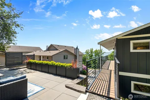 a view of a house with a balcony and yard