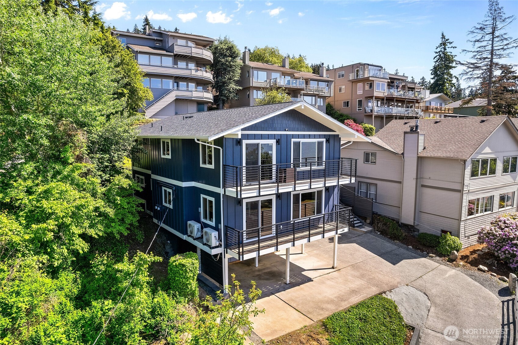 201 South State Street, Unit B Bellingham, WA 98225 - Photo 33 of 40 a view of a white building among the plants and large trees