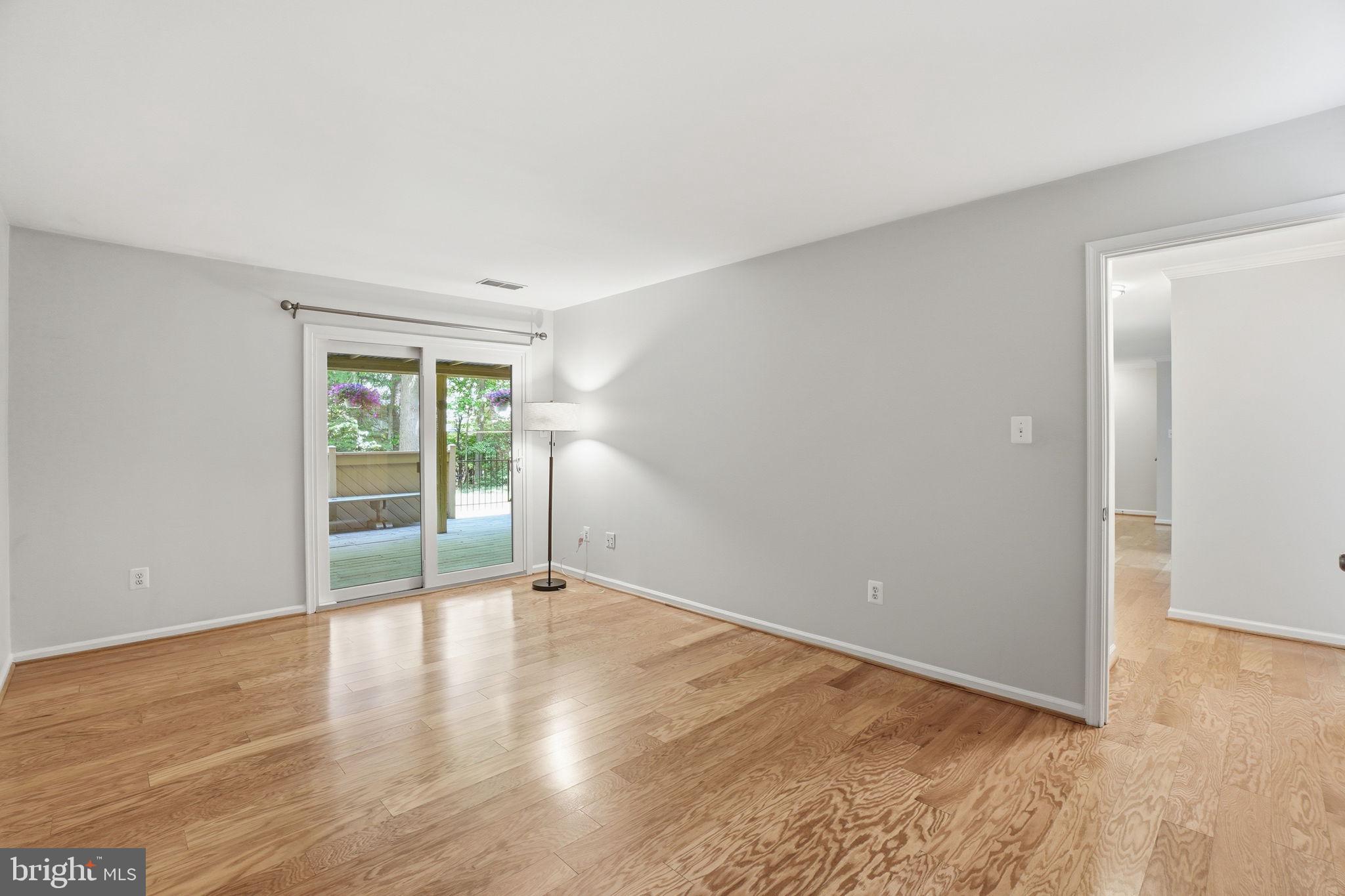 1495 Church Hill Place Reston, VA 20194 - Photo 14 of 27 a view of an empty room with wooden floor and a window