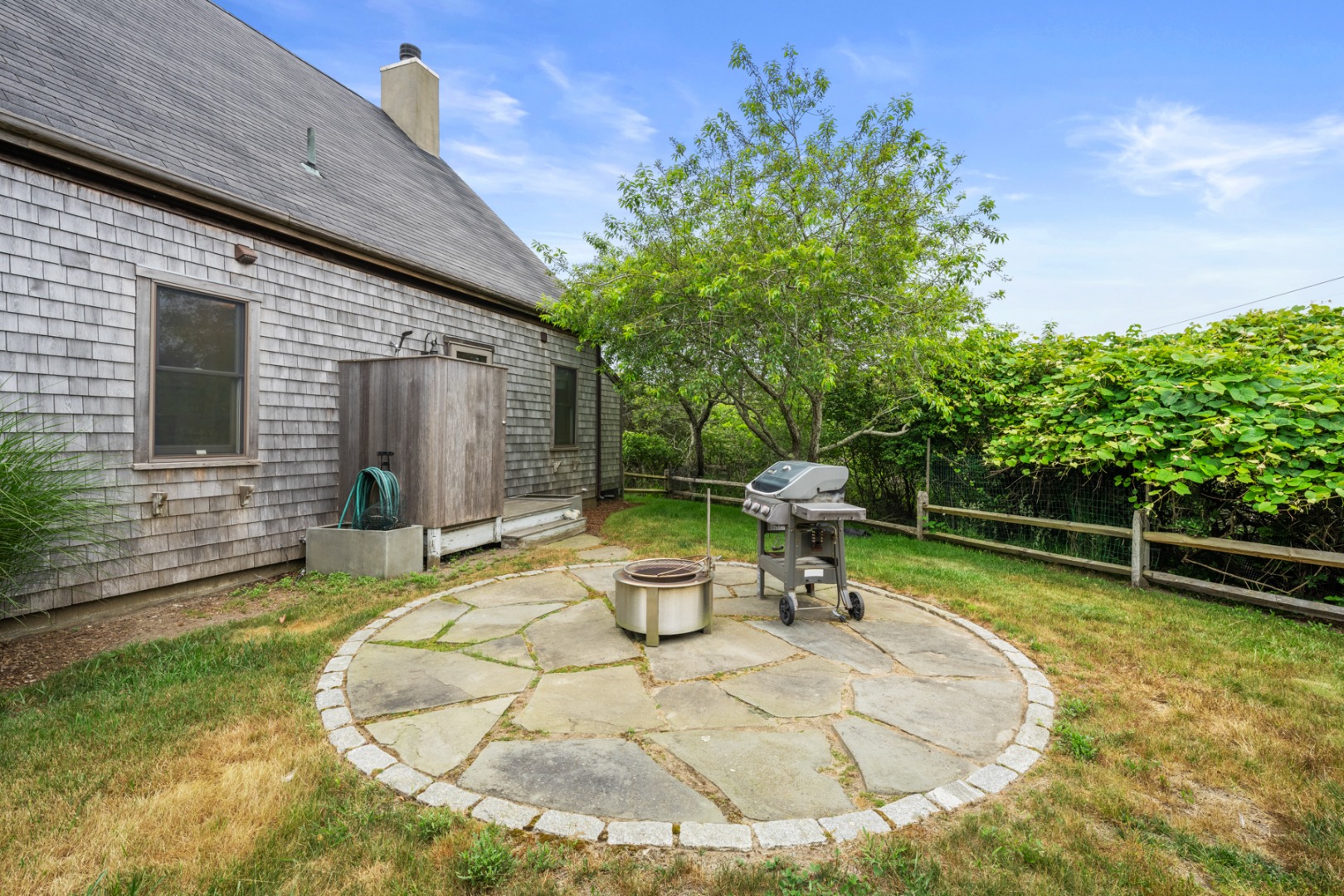 4 Berkley Street Nantucket, MA 02554 - Photo 43 of 47 a backyard of a house with barbeque oven table and chairs