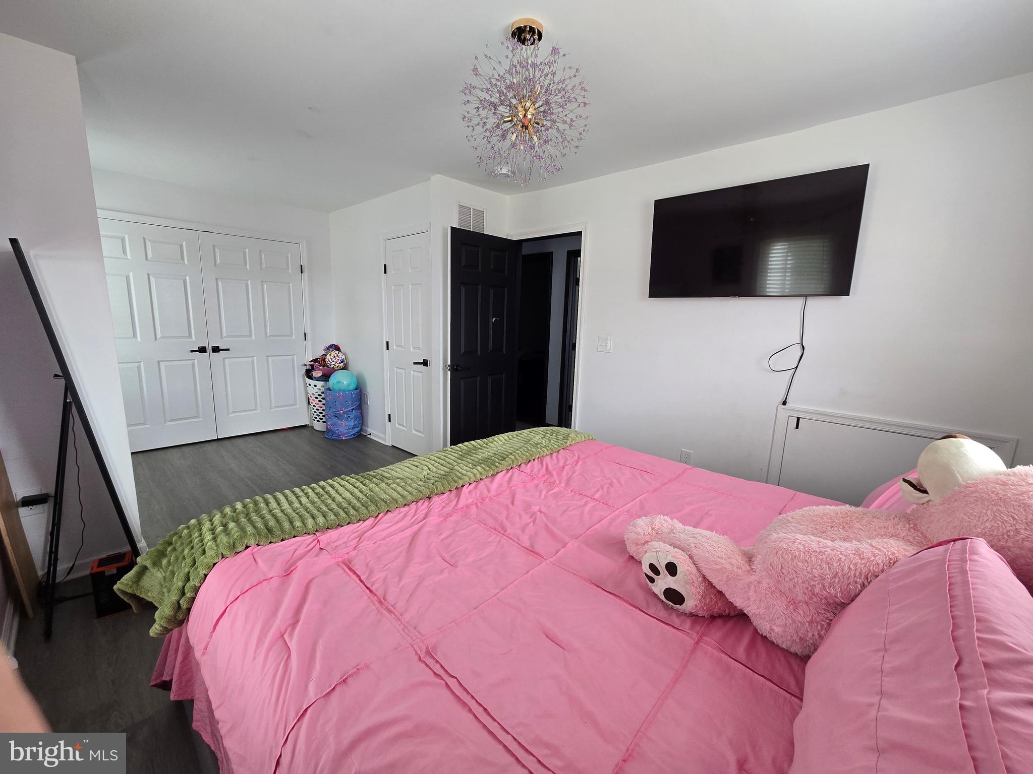 7513 Saffron Court Hanover, MD 21076 - Photo 16 of 42 a bedroom with a bed and a flat screen tv