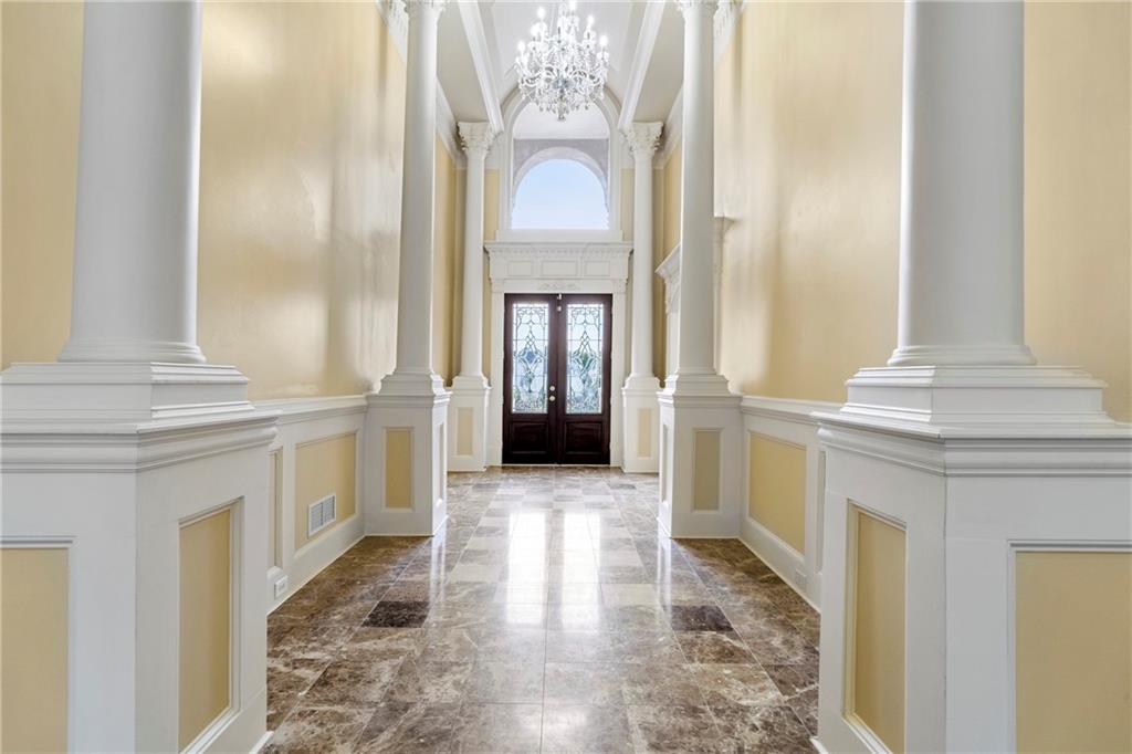 a view of a hallway with windows and entryway