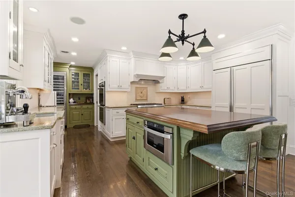 a kitchen with stainless steel appliances granite countertop a stove and a refrigerator