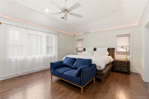 a spacious bedroom with a bed couch and a window