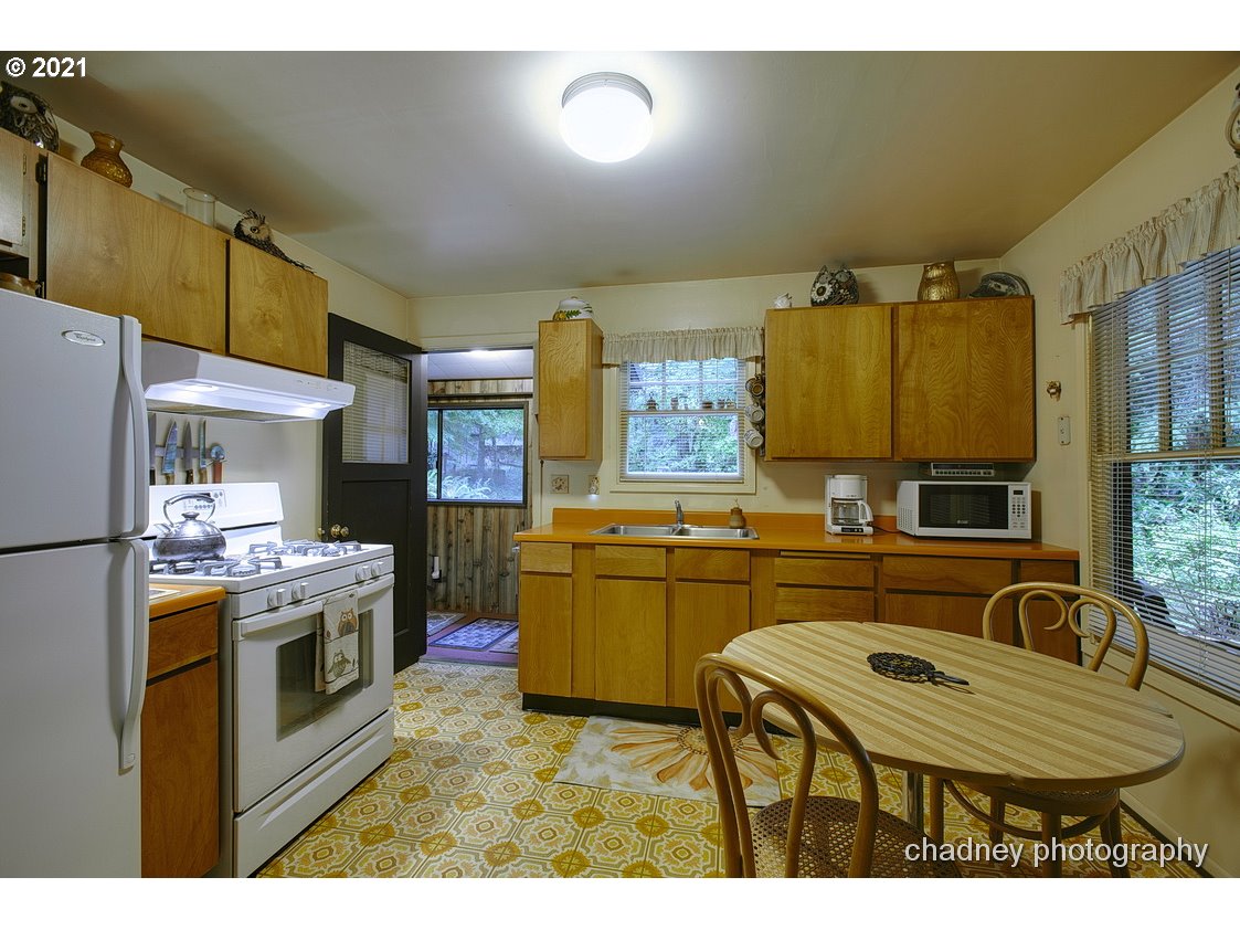 71594 East Minikahda Avenue Rhododendron, OR 97049 - Photo 9 of 27 a kitchen with sink cabinets and outdoor living room