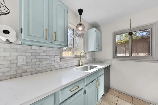 a kitchen with stainless steel appliances white cabinets and a stove