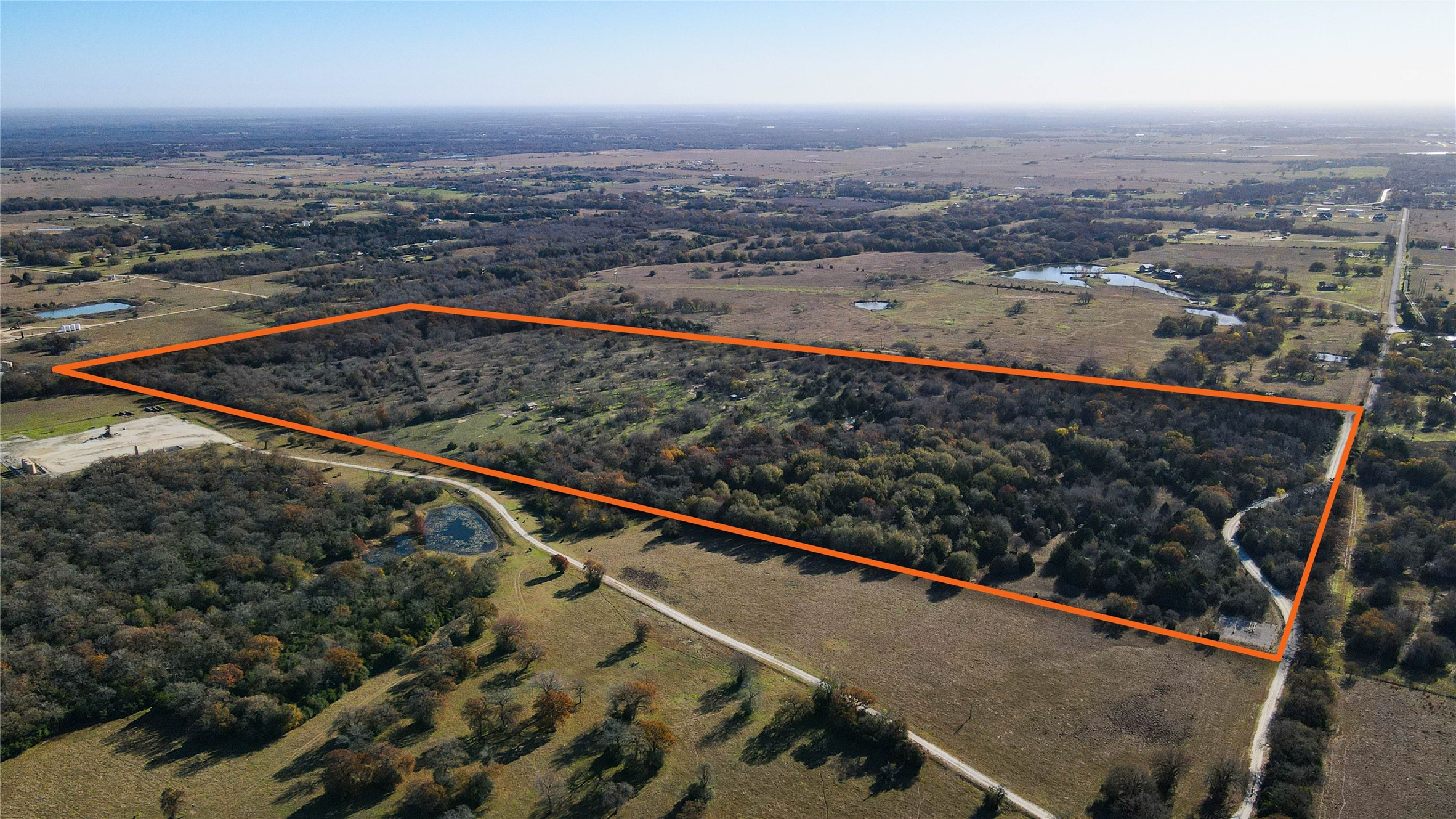 6833 Mensik Road Bryan, TX 77808 - Photo 6 of 6 an aerial view of residential houses with outdoor space