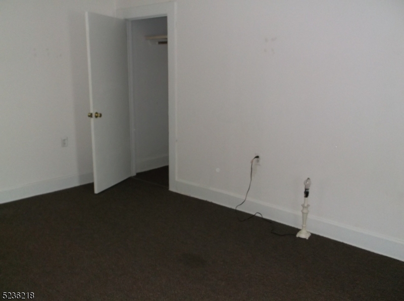 2 Plane Street, Unit C Butler, NJ 07405 - Photo 4 of 9 a view of a livingroom with wooden floor and a ceiling fan