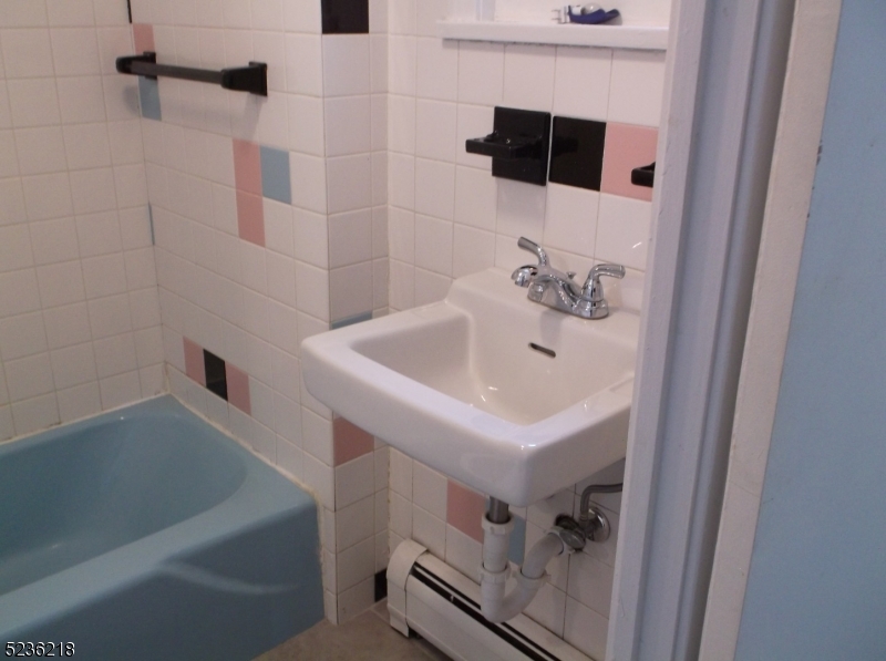 2 Plane Street, Unit C Butler, NJ 07405 - Photo 7 of 9 a bathroom with a sink a toilet and shower