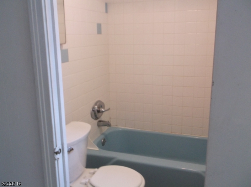 2 Plane Street, Unit C Butler, NJ 07405 - Photo 8 of 9 a white toilet sitting next to a bath tub