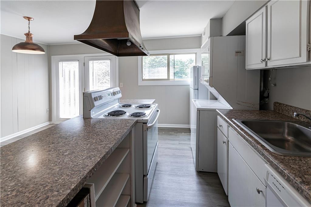 3071 Colonial Way, Unit E Atlanta, GA 30341 - Photo 8 of 16 a kitchen with granite countertop a sink stove and cabinets