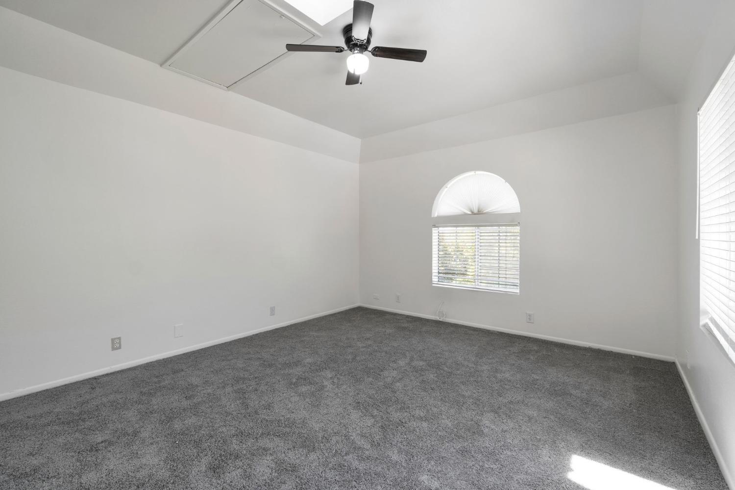 2832 East Westfall Road Mariposa, CA 95338 - Photo 15 of 38 an empty room with a chandelier fan and windows
