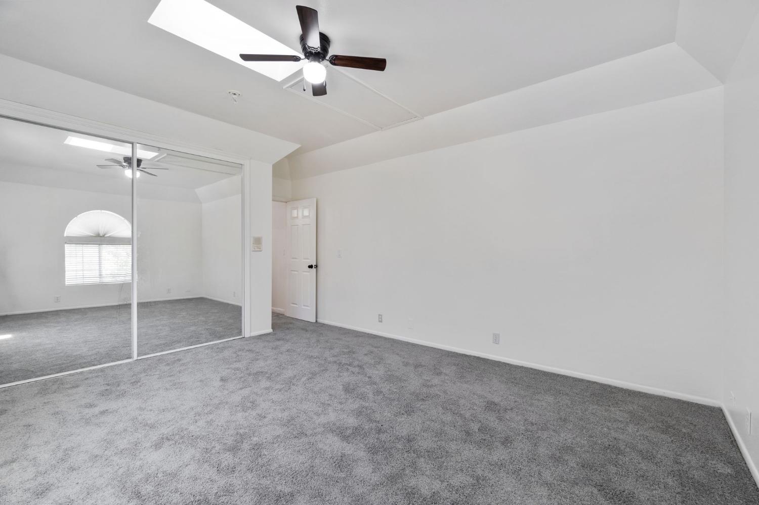 2832 East Westfall Road Mariposa, CA 95338 - Photo 16 of 38 an empty room with a ceiling fan and a window