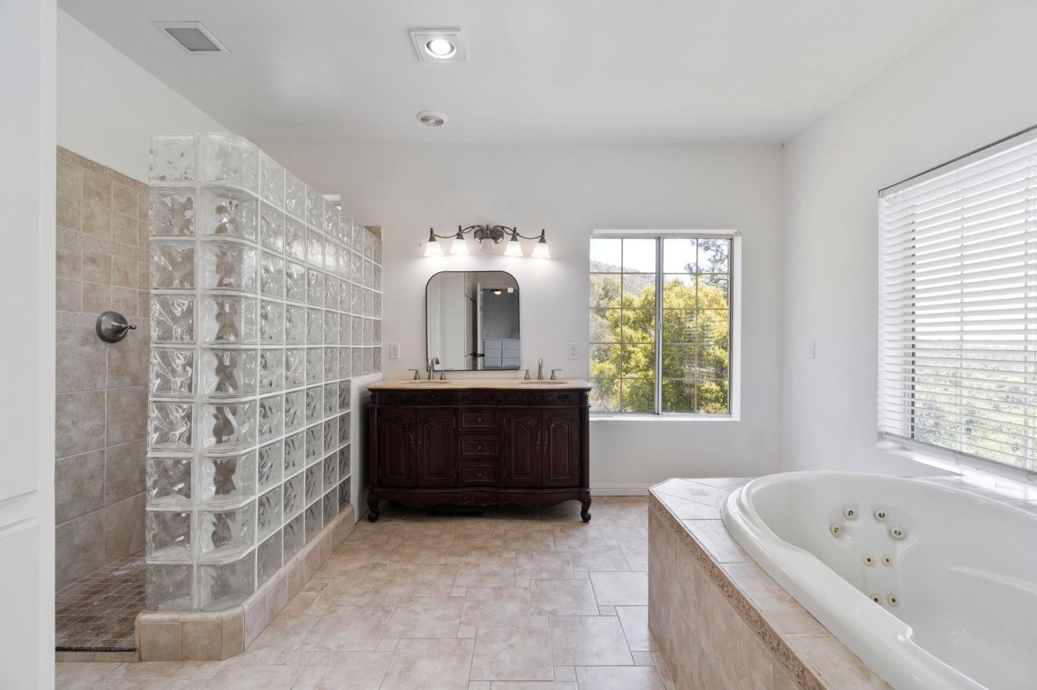 2832 East Westfall Road Mariposa, CA 95338 - Photo 19 of 38 a bathroom with a bathtub sink and window