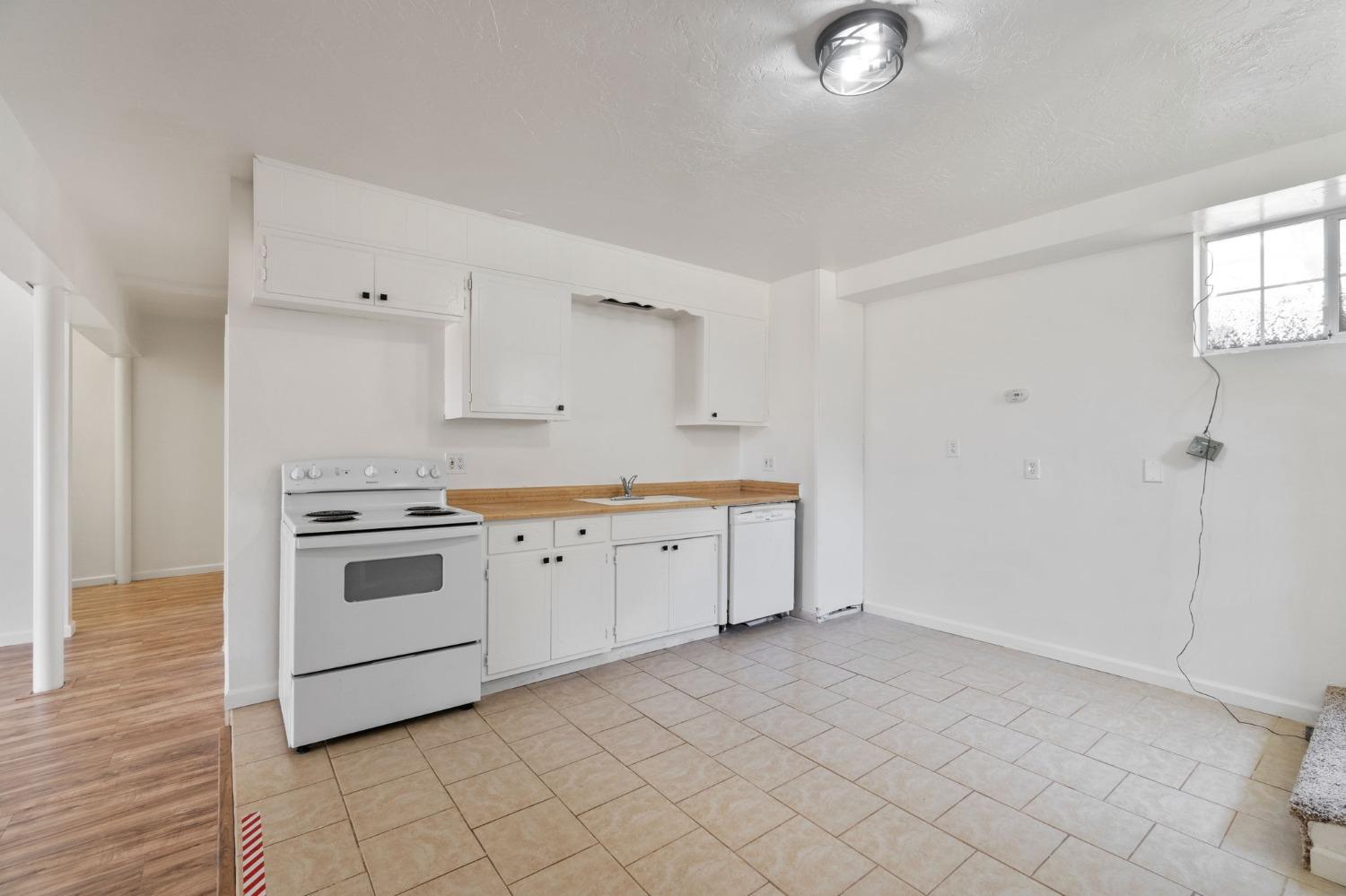 2832 East Westfall Road Mariposa, CA 95338 - Photo 23 of 38 a kitchen with granite countertop white cabinets and white appliances