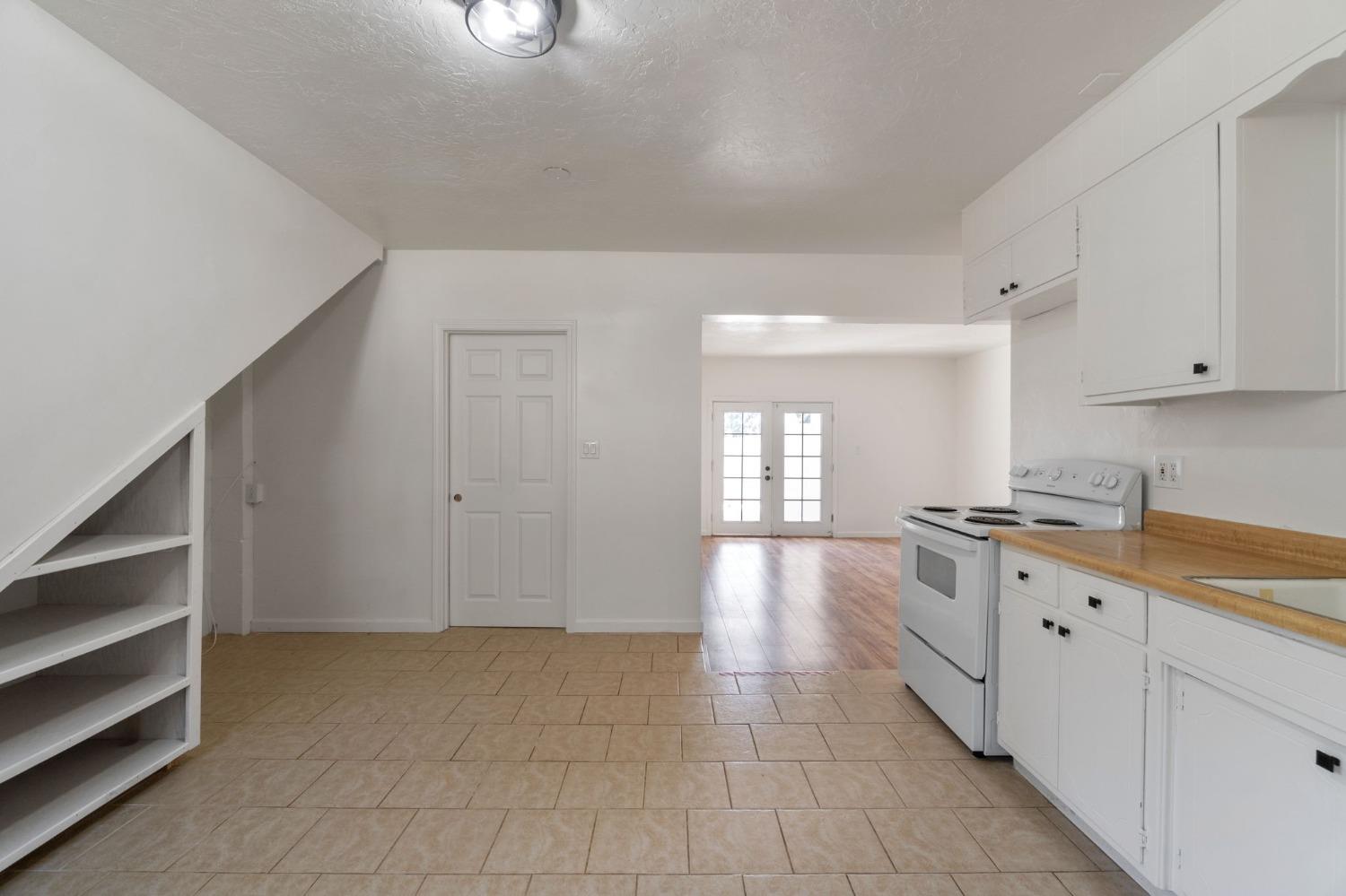 2832 East Westfall Road Mariposa, CA 95338 - Photo 24 of 38 a large kitchen with granite countertop a stove a sink dishwasher and cabinets with wooden floor