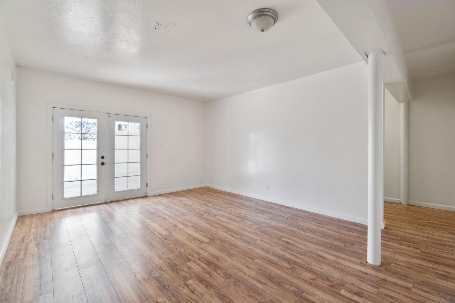 2832 East Westfall Road Mariposa, CA 95338 - Photo 25 of 38 a view of an empty room with wooden floor and a window