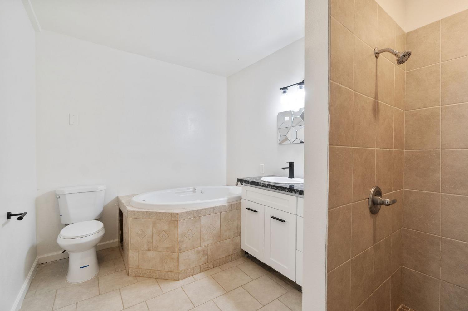 2832 East Westfall Road Mariposa, CA 95338 - Photo 28 of 38 a bathroom with a granite countertop toilet a sink and mirror
