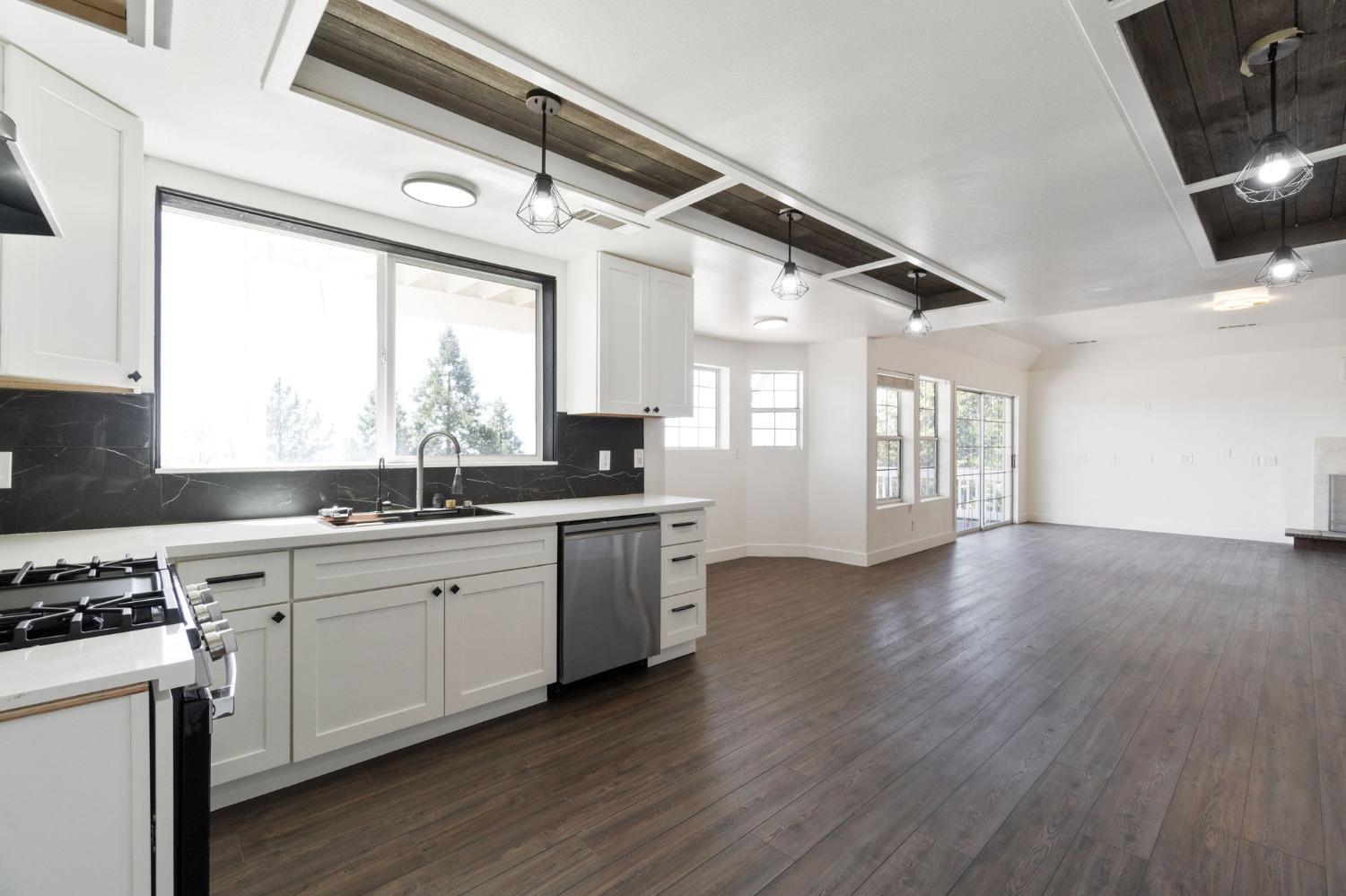 2832 East Westfall Road Mariposa, CA 95338 - Photo 10 of 38 a kitchen with a sink wooden floor and a stove