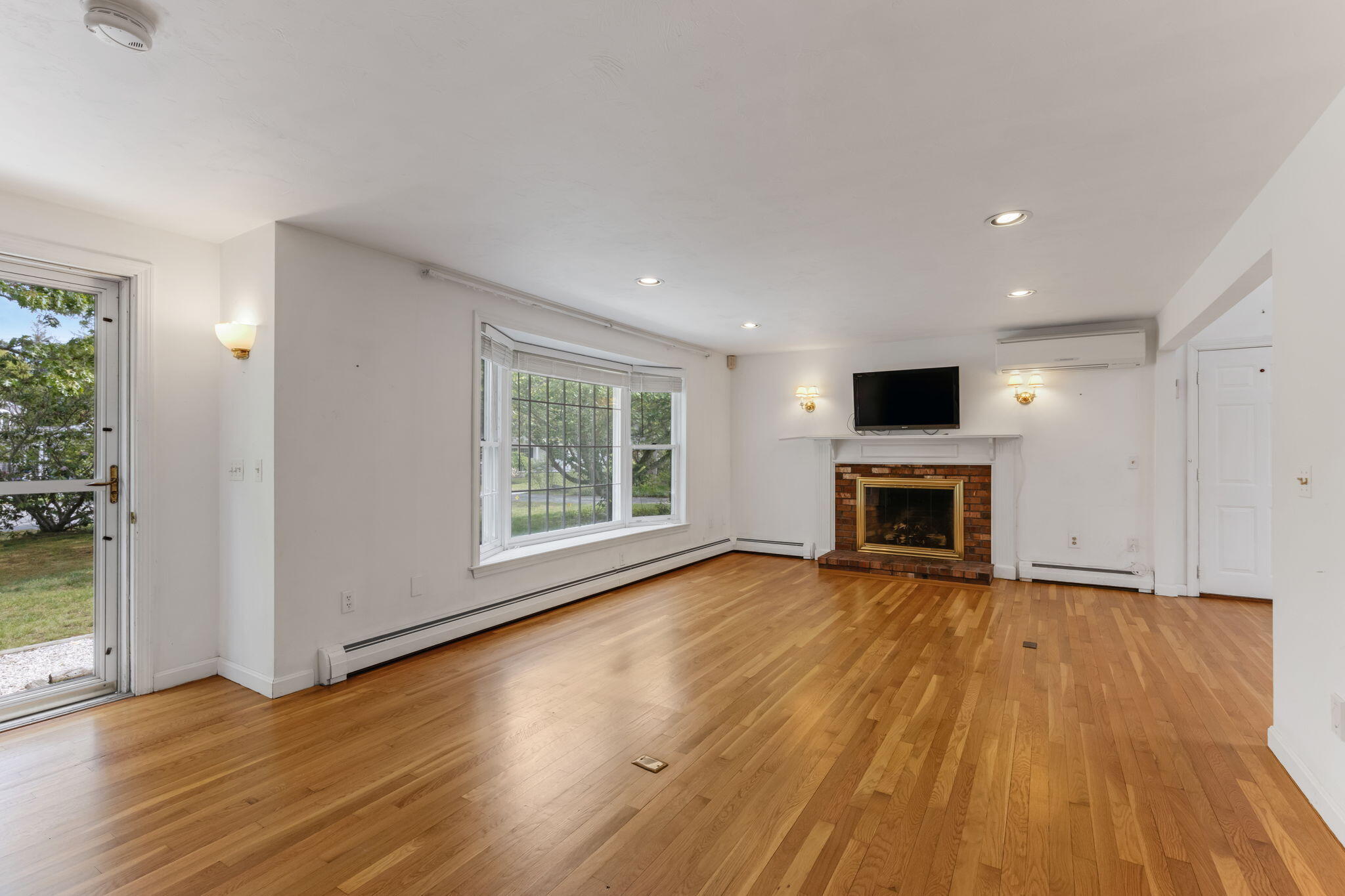 100 Potonumecot Road Chatham, MA 02633 - Photo 5 of 40 a view of a livingroom with wooden floor and a fireplace