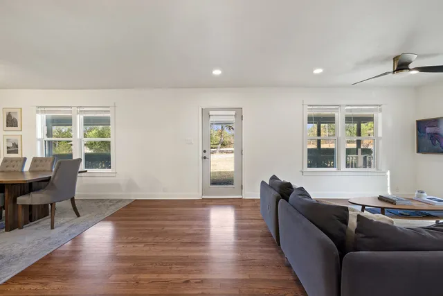 a living room with furniture window and wooden floor