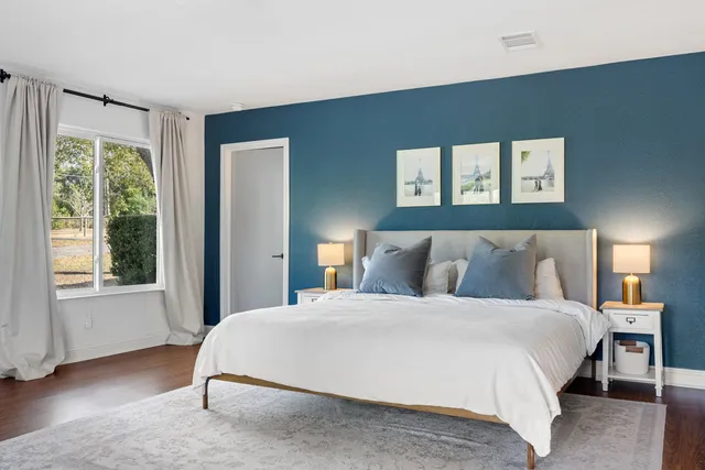 a bedroom with a large bed and a large window