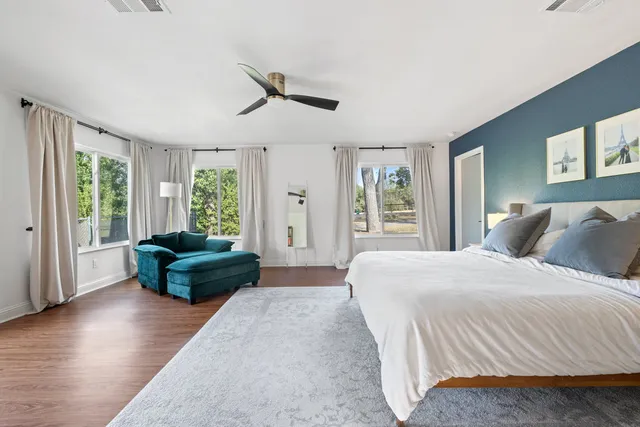 a bedroom with a bed window and a couch