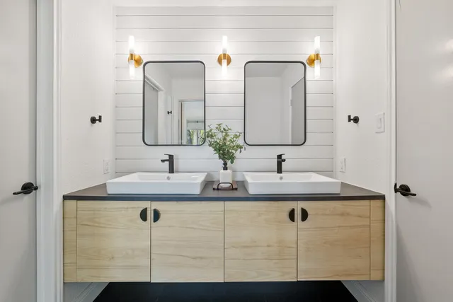 a bathroom with double sink and mirror