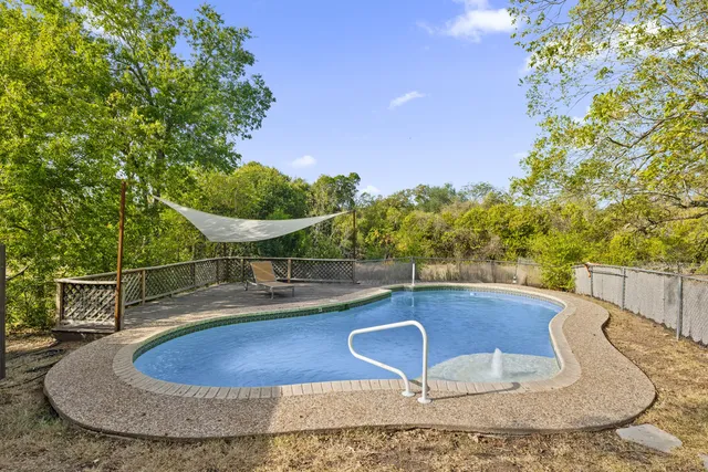 a view of a swimming pool with a yard